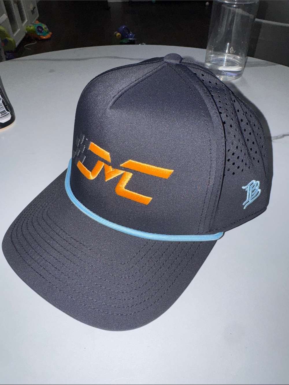 Men's Black Trucker Hat with Orange Logo and Light Blue Trim